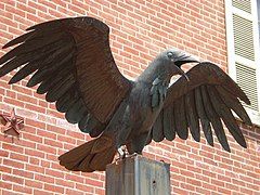 A detail of the raven statue outside the home.