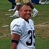 Headshot of Aeneas Williams on a football field wearing his uniform but no helmet