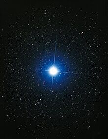 The star Sirius. It is shown as blue and is significantly larger and brighter than surrounding stars.