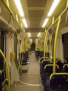 Entirely low-floor tram interior with single seats on one side of the aisle and double seats on the other