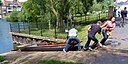 ☎∈ A punt being pulled up rollers on the slipway between the upper and lower levels of the River Cam near the Mill Pool in Cambridge, England.