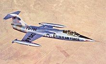 XF-104 prototype in flight over desert