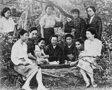 11 Japanese women photographed as a group, outdoors, in 1946; five of the women are wearing kimonos, the rest are wearing western blouses and skirts.