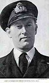 Head and shoulders picture of Robert Peverell Hichens in Royal Navy dress uniform of peaked hat, buttoned tunic, white shirt and black tie.