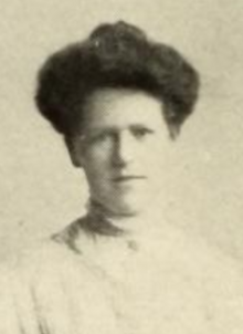 A young white woman with dark hair in a bouffant updo