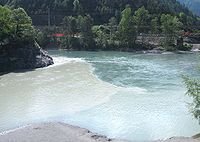 The confluence of the Vorderrhein and Hinterrhein to form the Alpine Rhine (left) near Reichenau GR