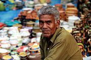 Although Hindi is the official language of India, Telugu is the official language of the state of Telangana, and Urdu its second official language.[4] Shown here is a handicraft seller in Hyderabad, Telangana