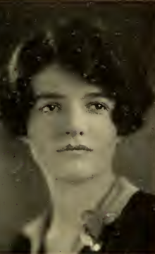 A young white woman with dark wavy hair cut in a bob with a sidepart