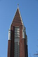 The bell-tower of the Église Saint-Antoine-de-Padoue. Two of the four statues of saints can be seen near the top.