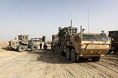 Photographed in Helmand Province, Afghanistan, this MK18 LVSR cargo variant is towing a M1076 PLST