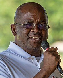 Photograph of Mboka Mwilambwe speaking into a microphone