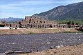 Taos Pueblo, a World Heritage Site, belonging to a Native American tribe of Pueblo people, marking cultural development during the Pre-Columbian era.