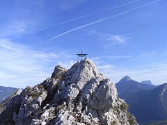 The peak is topped with a small metal cross.