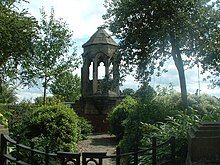 Shrewsbury Abbey refectory pulpit surrounded by trees.