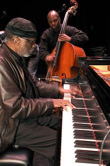 James Cammack plays double bass with pianist Ahmad Jamal in the foreground.