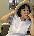 Woman wearing a white blouse and a straw hat