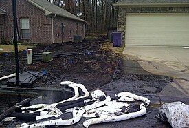 black liquid between houses and on walls of house