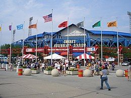 The red, white, and blue façade of a steel and concrete ballpark