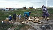 Inuit women in Kugluktuk preparing to make bannock. From the late 1970s or early 1980s.