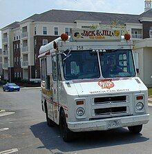 A van which says "watch children" on the front