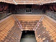 Traditional courtyard (nadumuttom) surrounded by woodwork window benches (charupadi)