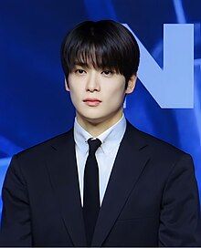 Jaehyun wearing a formal attire for NCT 127's Fact Check press conference.