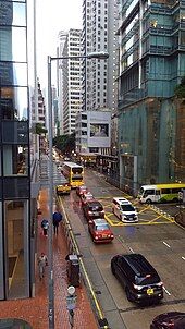 Western end of Queen's Road East on a rainy day, viewed from the overpass. Three Pacific Place is on the right. Hopewell Centre is visible in the distance.