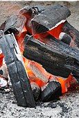 A charcoal fire; charcoal is a lower-smoke fuel than wood, as much of the pyrolysis products have already been released, and oxidizing the carbon produces only CO2 (and CO, if there is a lack of oxygen).