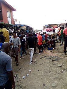 multiple people on busy street around market