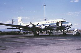 A photograph of an aircraft with four propellers in the air