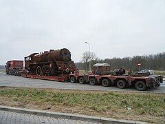 Steam locomotive on lowboy