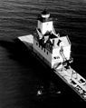 The lighthouse as seen after the tower was built into the roof of the fog signal building. This change occurred in 1931 and left the lighthouse looking as it does today.[8] This image was taken in the 1950s, prior to the pier being widened and capped.