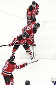 New Jersey Devils forward Travis Zajac (#19, foreground) instructs Nick Palmieri (#32), Mark Fayne (#34), and Ilya Kovalchuk (#17) prior to faceoff