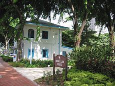 A park signboard with the Kreta Ayer Neighbourhood Police Post visible in the background.