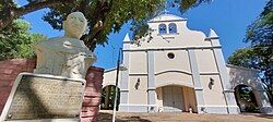 Church in Itape behind the sculpture of its founder Buenaventura de Villasboa