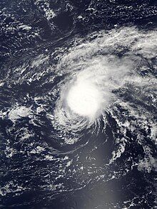 Satellite image of a cyclone where the thickest clouds are displaced from the central vortex