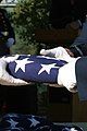 An Air Force honor guard folds the American flag after presenting it to the families of the first veterans buried.