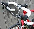 A threadless stem with a removable face plate on a racing bicycle holding drop handlebars.