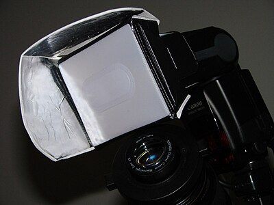 A more formal diffuser filter over a camera flash, flanked by reflectors