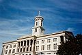 Photograph of the Tennessee State Capitol on a sunny day, the central cupola soaring against a clear sky.