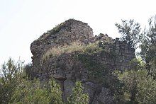 Overgrown ruins of a castle on a hill