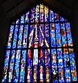 Stained glass over front door, with Jesus on a surfboard at top left