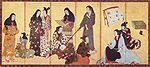 Nine women and a girl dressed in kimonos. One woman is reading a sheet of paper, another is playing a shamisen. One woman is doing the hair of another woman.