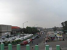 Picture of Line 9's elevated railway and below multiple transport units are parked.