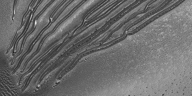 Close view of the end of gullies in Russell Crater, as seen by HiRISE. Note: These type of gullies do not usually end with an apron.