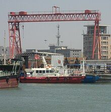 A small fast boat with white hull with red superstructure