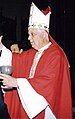 Bishop Alejandro Goic is shown wearing a red chasuble and a white miter