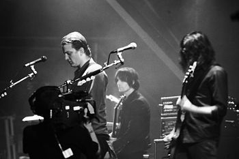 Left to right: Josh Homme, Dean Fertita and Michael Shuman performing at the Eurockéennes festival, July 2007