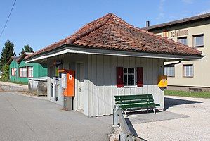 One story building with ticket machine and bench