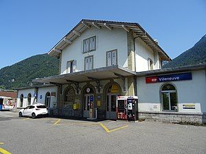 Three-story building with gabled roof and multiple wings